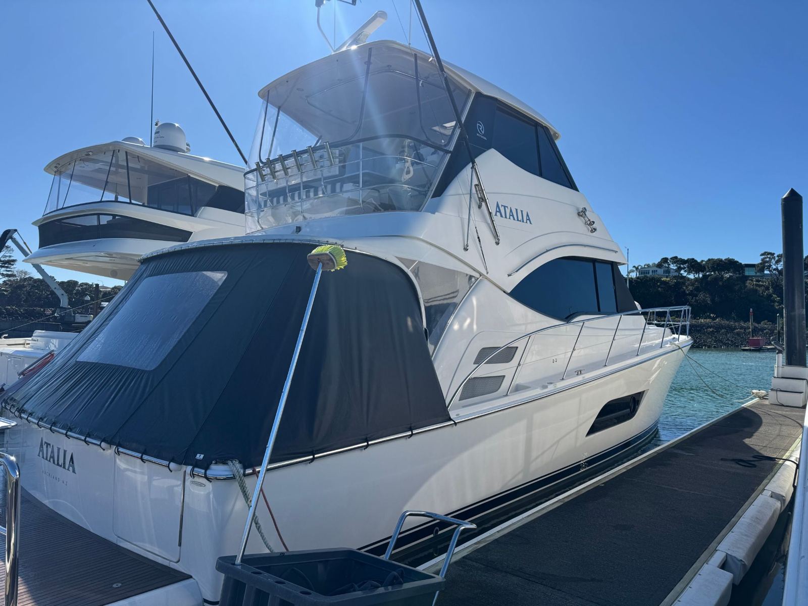 Flybridge cruiser in the sun at the marina