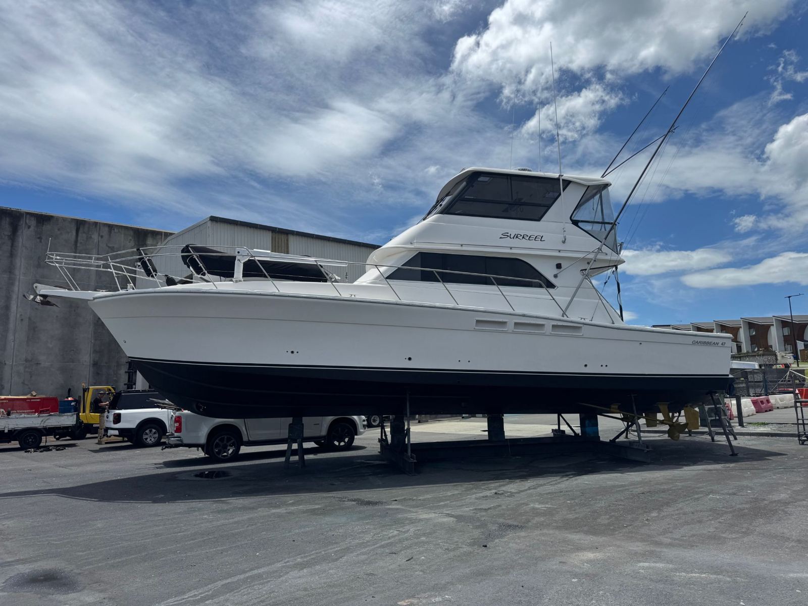 White flybridge cruiser on the hardstand after a full cut and polish
