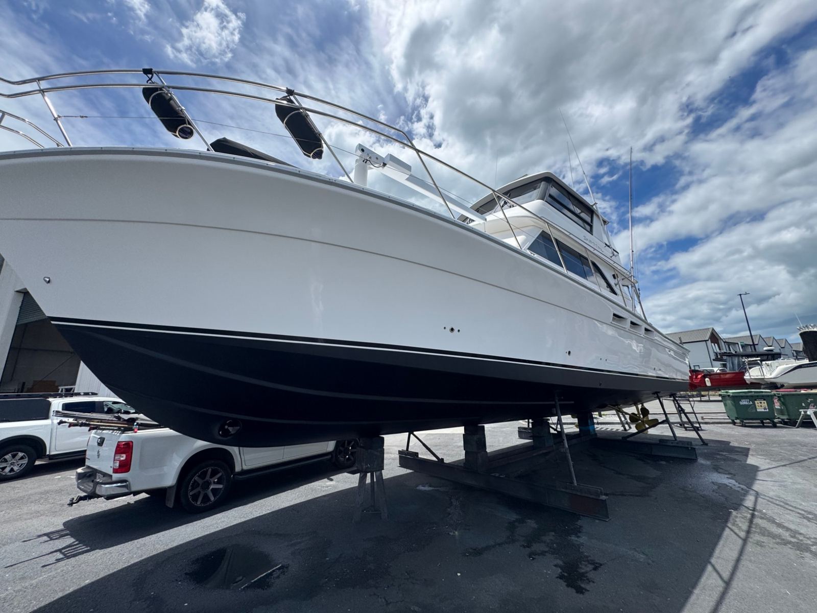 Polished white hull and dark antifoul on the hardstand