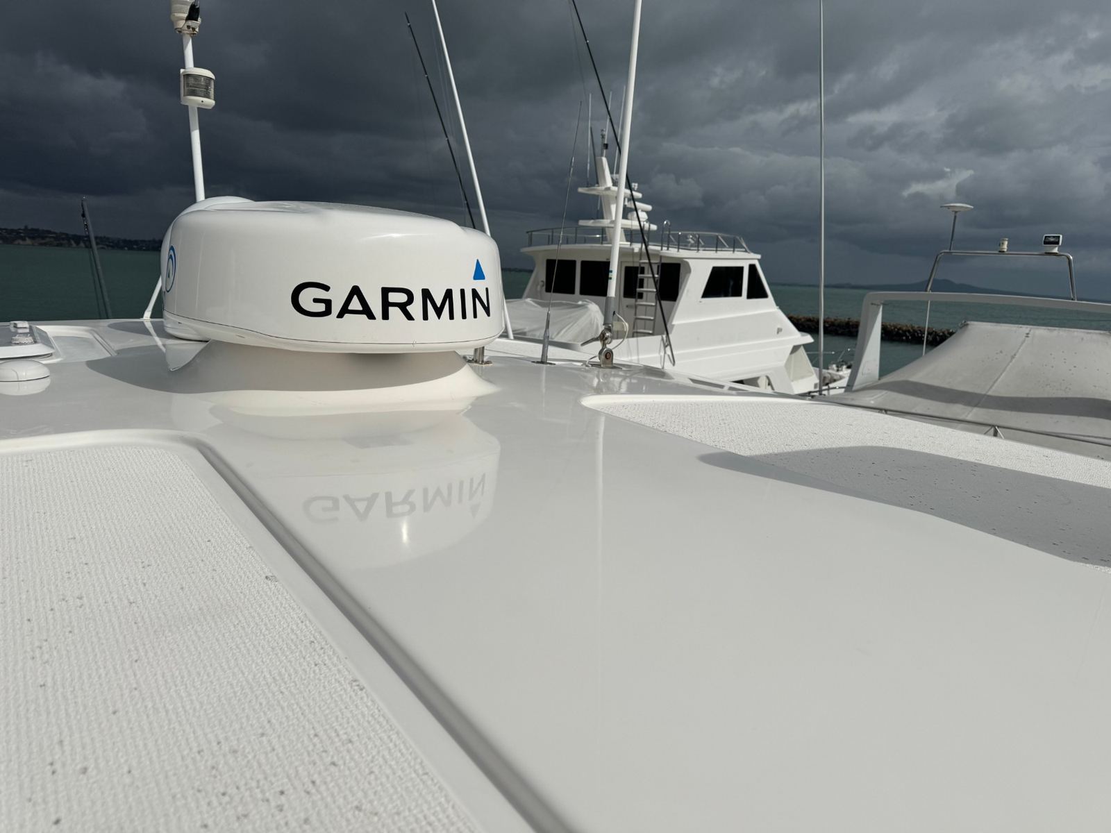Radar dome reflected clearly in a freshly polished white hardtop