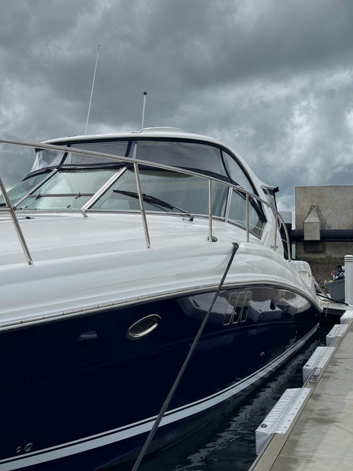 Navy hull sport cruiser under stormy skies